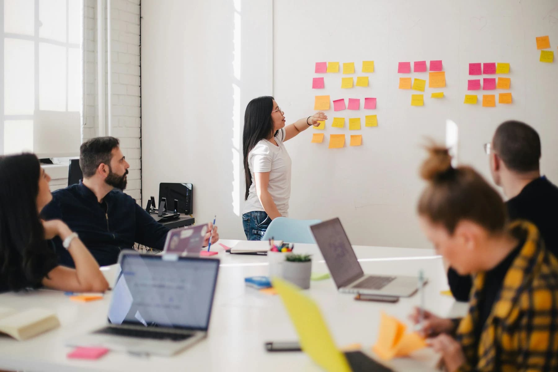 A multidisciplinary team reviewing a shared workflow during a collaborative workshop